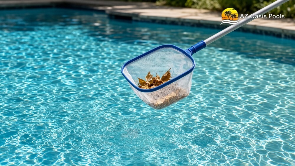 Leaf skimmer net lifting debris from a sparkling turquoise backyard pool